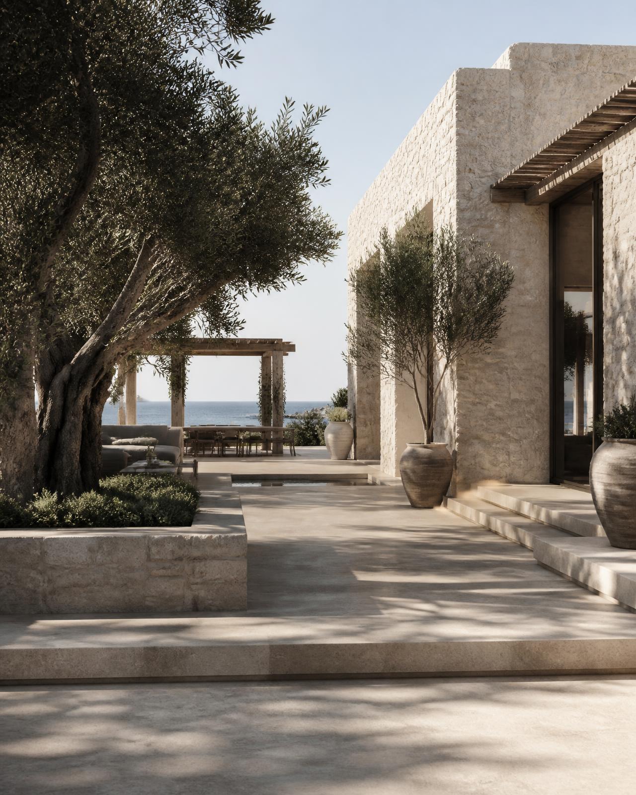 Coastal estate villa in natural limestone with olive trees and shaded terraces